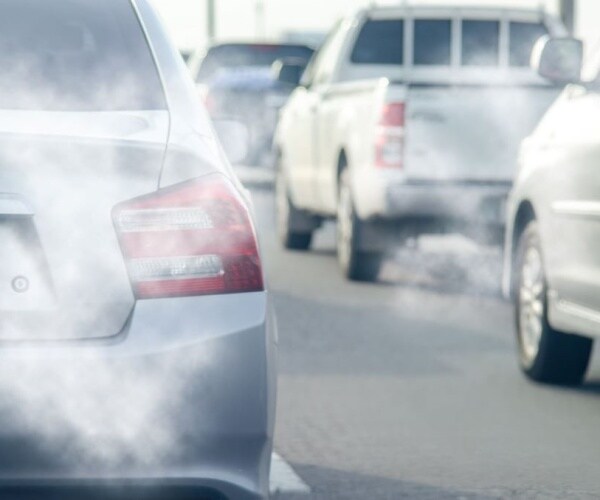 cars on highway with exhaust