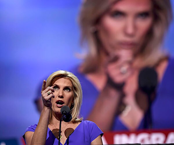 laura ingraham points up on stage during a convention while a large image behind her is also pointing at the crowd