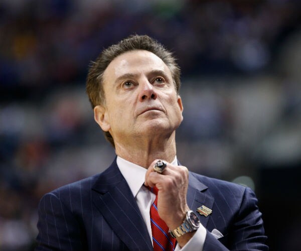 Rick Pitino is shown in a blue pinstripped suit, red, blue and white tie and white dress shirt