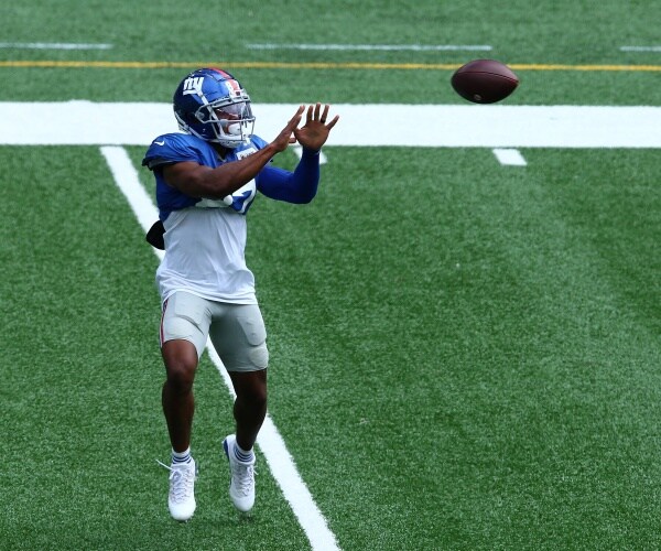 ny giants player catches the football