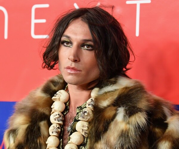 ezra miller poses on the red carpet