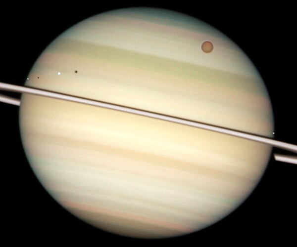 a view of saturn and its rings and many moons