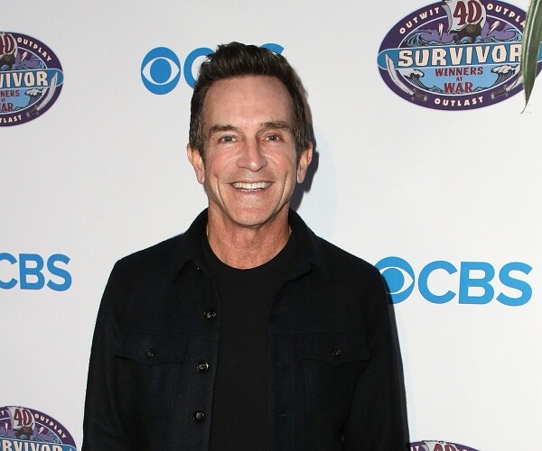 jeff probst stands on red carpet