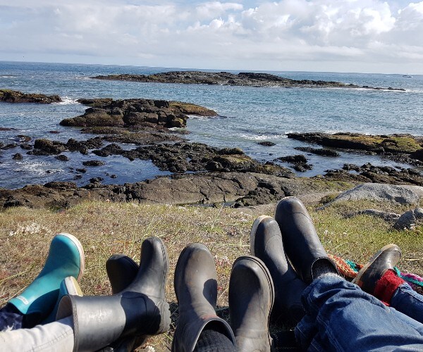 family wearing boots on a beach