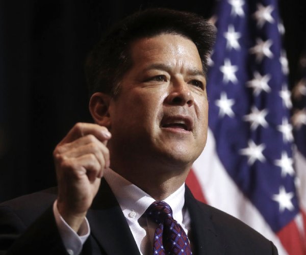 tj cox speaks at a rally