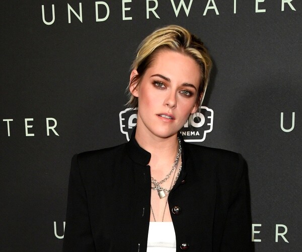 kristen stewart stands on red carpet