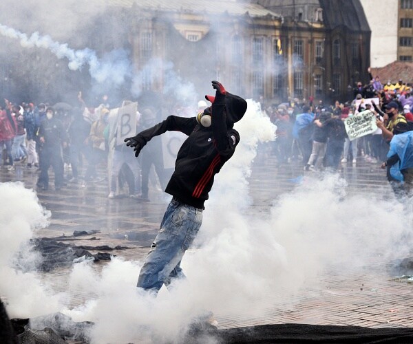 protester stands in tear gas smoke