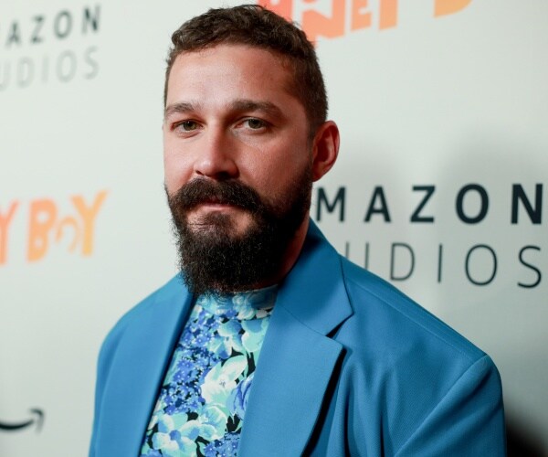 labeouf in a blue blazer and blue floral shirt