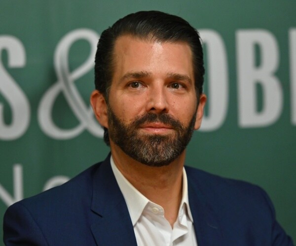 don jr in a suit and white shirt at a barnes and noble event