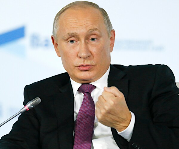 vladimir putin pumps his left fist during a news conference