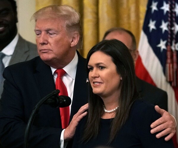 donald trump side hugs sarah huckabee sanders
