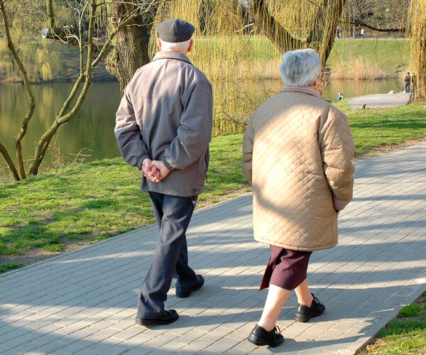a senior couple walking in a park