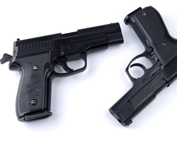 two black handguns on a white background