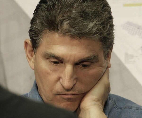 joe manchin is shown looking as if he's in deep thought