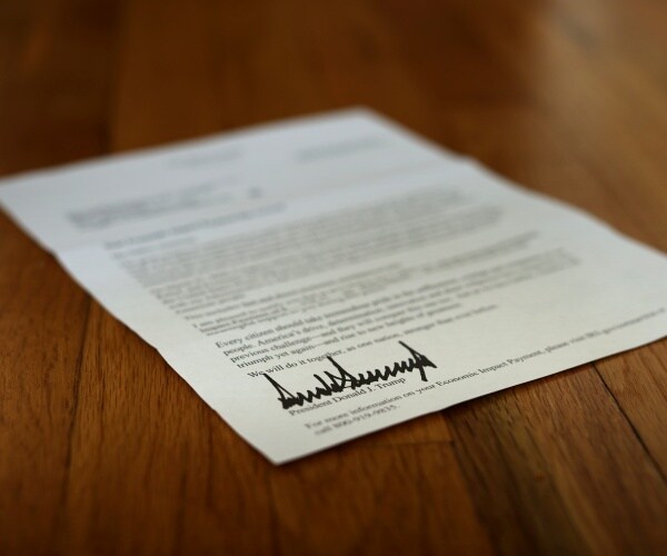 letter with trump's signature sitting on a wood table