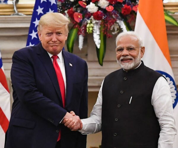 india's prime minister marendra modi is shown shaking hands with donald trump