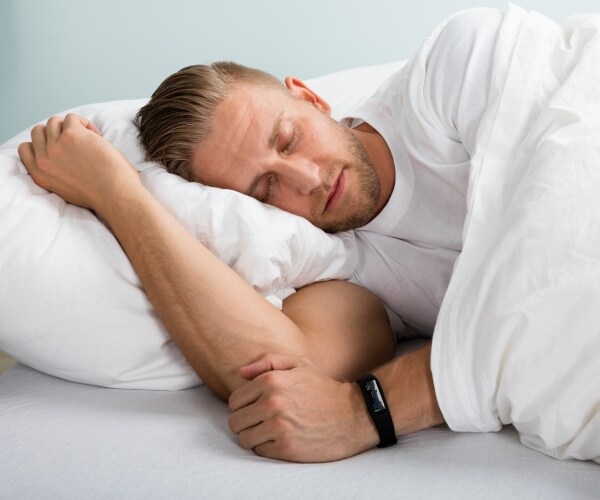 a man sleeping in a bed