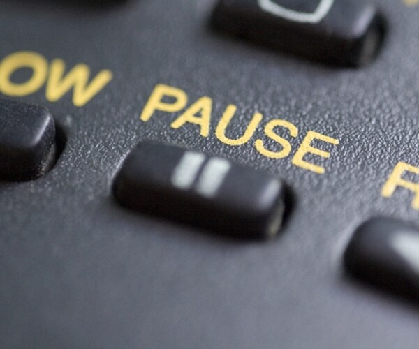 close up of the pause button on a remote control 