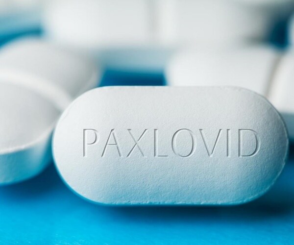 close up of white pill with 'Paxlovid'