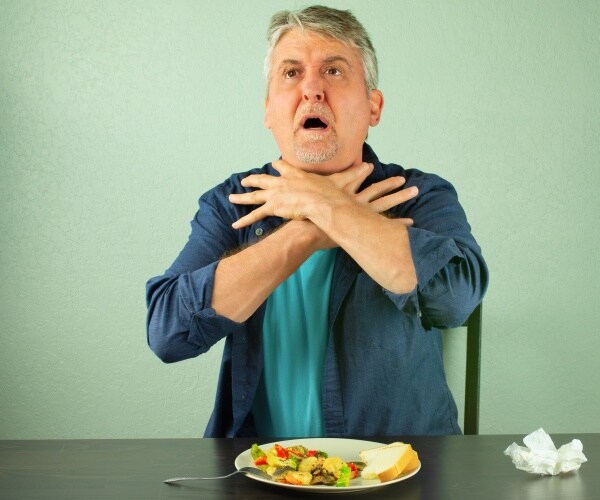 man with hands to throat choking