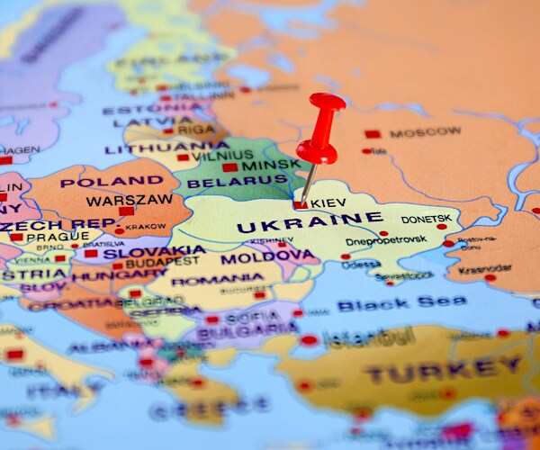Pinned Ukraine on map of Europe, closeup. International relationships