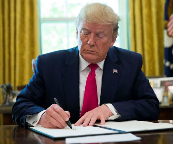 us president donald trump signing an executive order 