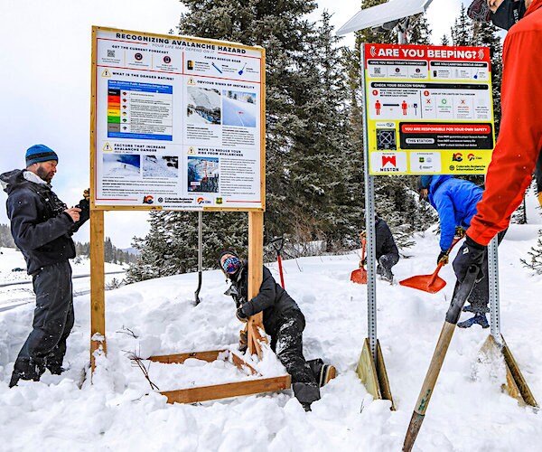The avalanche danger and information sign is moved to accommodate a new beacon checkpoint sign