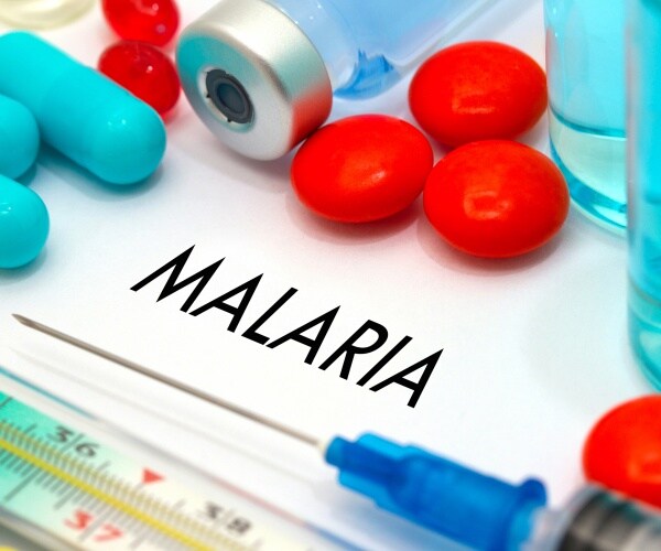 malaria treatments including pills and a syringe