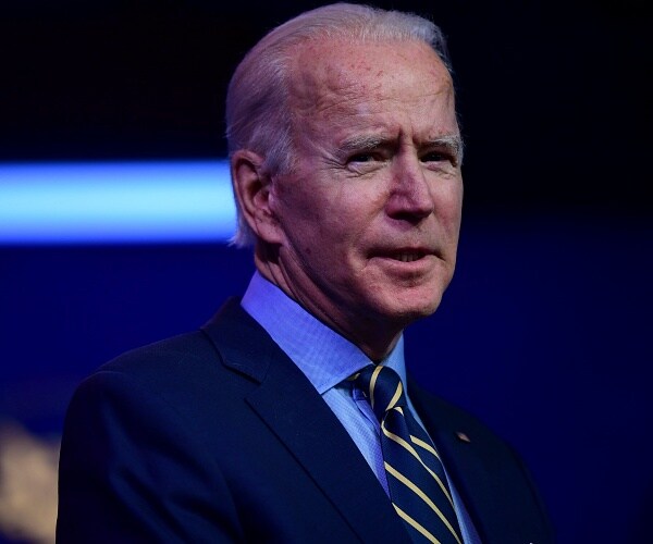 joe biden speaks into microphone