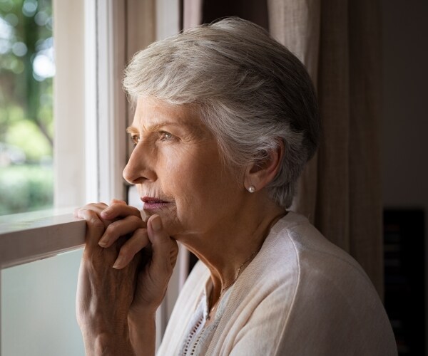 a woman looks out the window