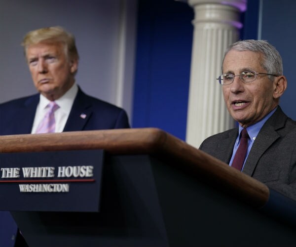 dr. anthony fauci is seen with president donald trump in the background