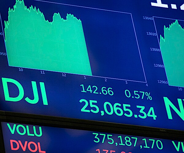 a computer screen shows the landmark moment the dow jones industrials average exceed 25,000 for the first time
