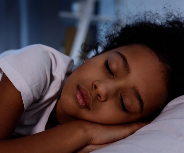 little girl sleeping in bed