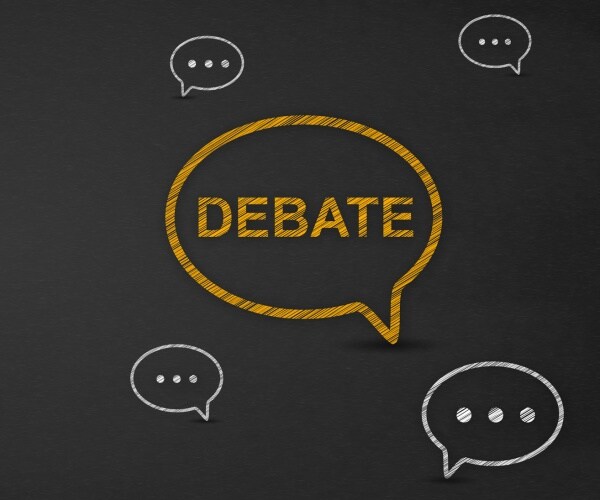 debate word in speech bubble on a blackboard
