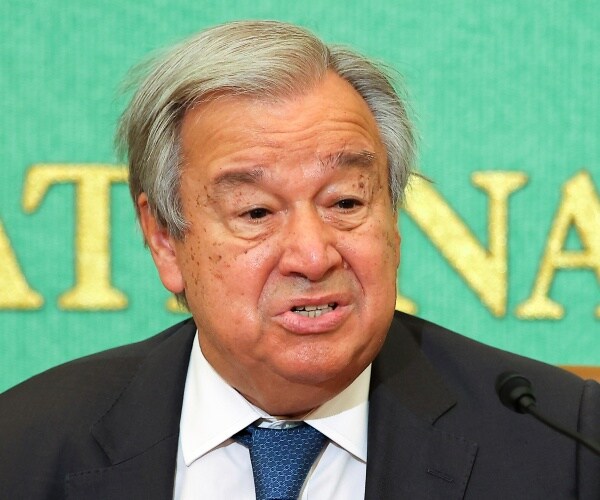 antonio guterres speaks into a microphone