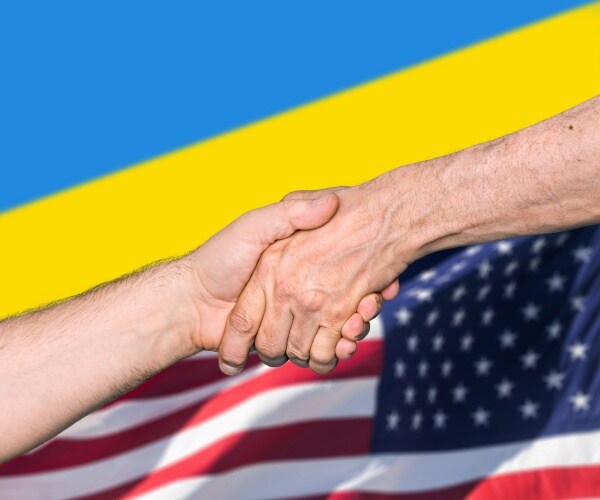 ukrainian and us flag men shake hands
