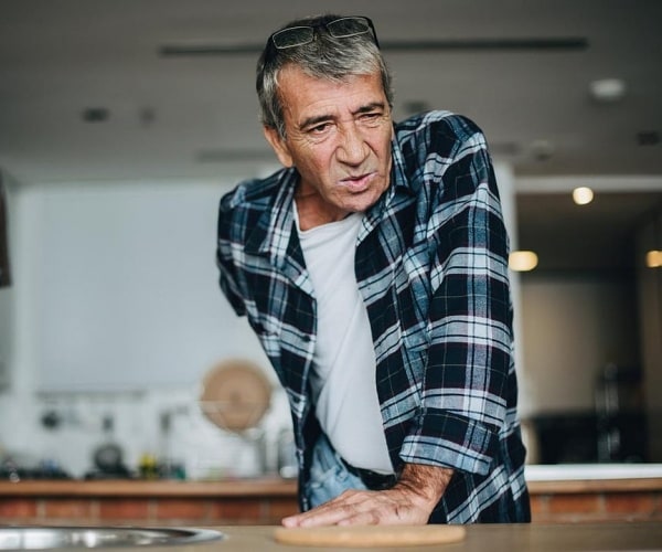 man leaning over with back pain