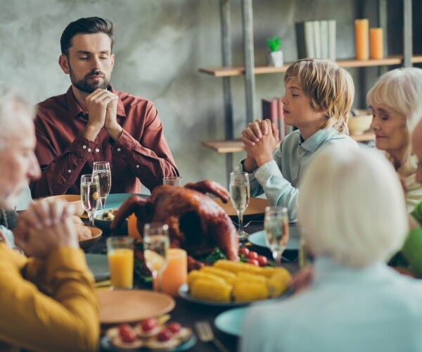 family around table at Thanksgiving