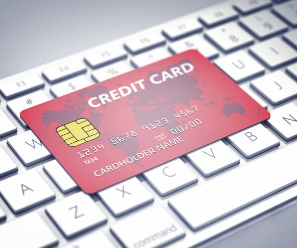 graphic shown a red credit card sitting on top of a keyboard