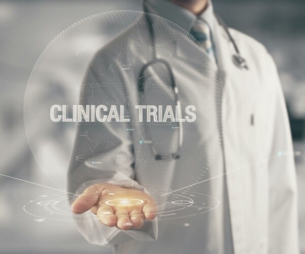 Doctor with hand out, labeled 'clinical trials'