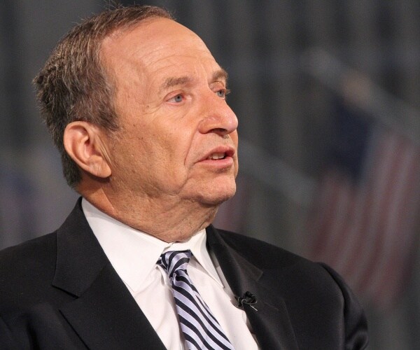 summers in a black suit and striped tie