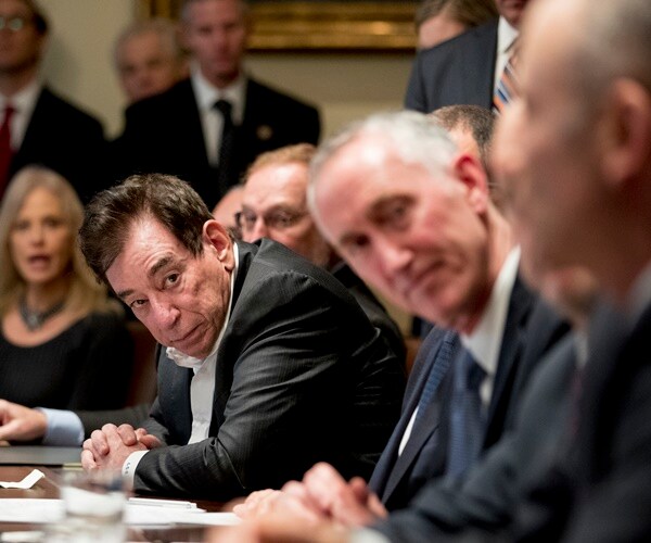 leonard schleifer looks at someone speaking in the foreground