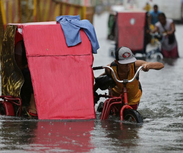 Typhoon Kills 2 People in Taiwan; Floods Hit Manila