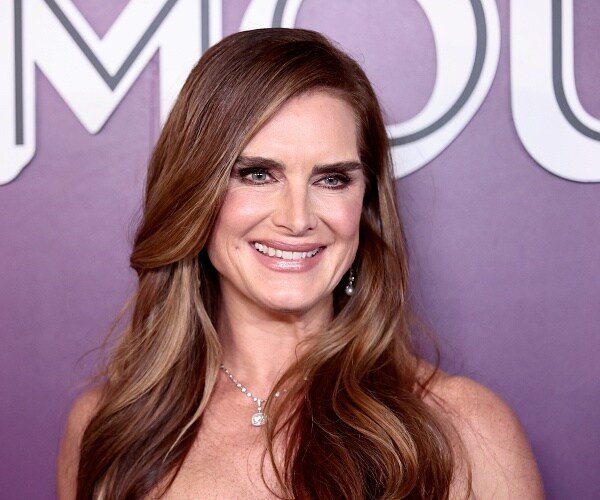 brooke shields stands on red carpet
