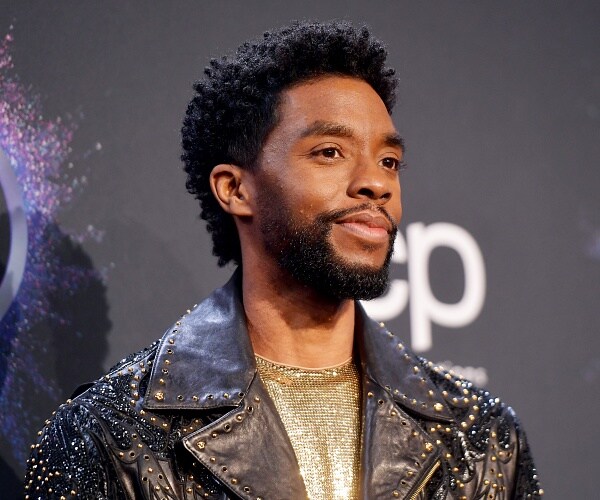 chadwick boseman stands for photo