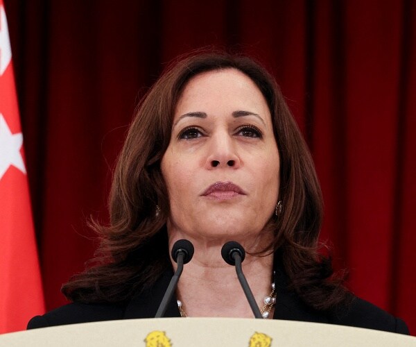 kamala harris stands behind podium