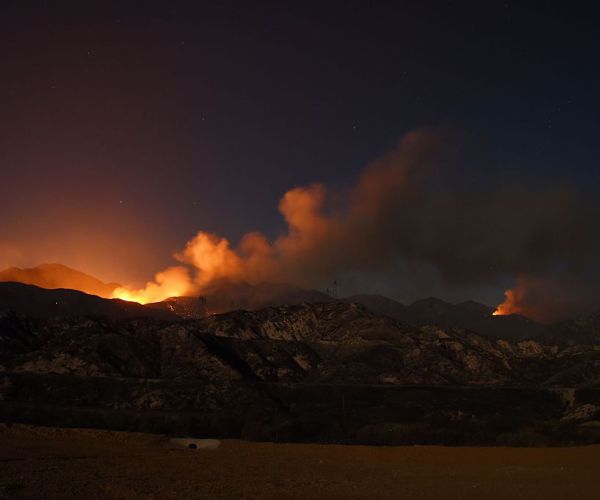 the blue cut fire burns after sunset in the mountains near wrightwood, california.
