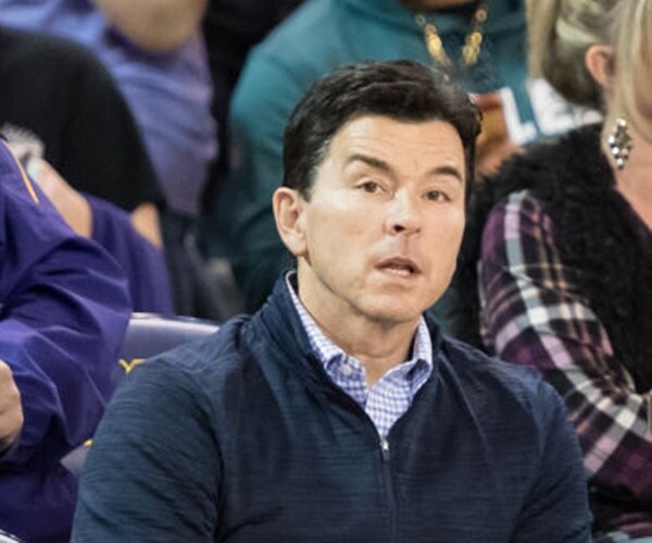 allen thomas sitting courtside during a basketball game
