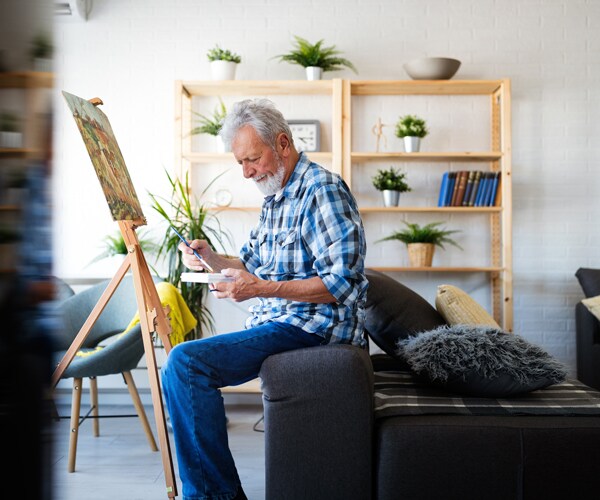 a man painting at home