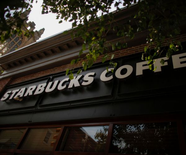 the starbucks logo outside a store in philadelphia, pennsylvania. 
